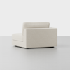 A modern, minimalist beige sectional sofa piece with a low backrest and clean lines, shown on a plain light gray floor against a white background.