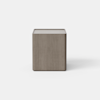 A modern wooden nightstand with a light brown finish, featuring two drawers; the top drawer is partially open. The nightstand stands on a smooth, light-colored surface against a plain background.