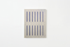 A rectangular metallic panel with two rows of vertical blue slots, mounted on a plain white wall. The design is minimalist and geometric.