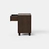 A minimalist, dark wood cabinet with clean lines and short legs, set against a plain white background.