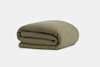 A neatly folded, olive green blanket with a subtle grid texture, placed on a plain white background.