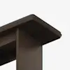 Close-up view of the corner of a dark wooden table with a sleek, modern design, featuring smooth edges and a dark top surface against a white background.