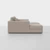Side view of a modern, light beige sectional sofa with two seat cushions and two back cushions, set against a plain white background. The sofa has a clean, minimalist design.