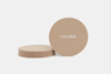 Four round, tan felt coasters with the word THUMA in white text; three are stacked while one is propped up against the stack on a white background.