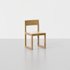 A simple wooden chair with a flat seat, straight backrest, and minimalist square frame, placed on a light gray floor against a plain white background.