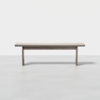 A simple wooden bench with a rectangular seat and straight legs, set against a plain white background.