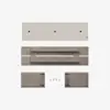 Top-down view of disassembled furniture parts, including a beige cushion, brown tabletop with bracket, two rectangular legs, and hardware, all neatly arranged on a white background.