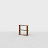 A small, simple wooden bookshelf with two shelves stands alone on a light gray floor against a plain white background.