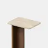 A modern table with a rectangular beige stone top and a vertical wooden base, shown against a plain white background.