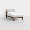 A single bed with a wooden frame, angled legs, a light gray upholstered headboard, and white bedding, positioned against a plain white wall on a light gray floor.