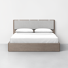 A modern, minimalist bed with a light wooden frame, a padded gray upholstered headboard, and white bedding with two pillows, set against a plain white wall and floor.
