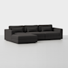 A modern, dark gray sectional sofa with a left-facing chaise lounge, three back cushions, and three rectangular throw pillows, set against a plain white background.