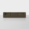 A modern, dark olive green modular sofa with three seating sections and a wooden base, set against a plain white background.