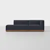A modern, dark navy sectional sofa with clean lines, low profile, and a wooden base, set against a plain light gray background.