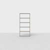 A tall, five-shelf wooden bookcase stands on a light grey floor against a plain white background. The shelves are empty and the design is simple and modern.