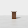 A minimalist wooden side table with a rectangular top featuring a narrow central gap, placed on a plain white background.
