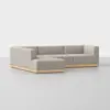 A modern, light gray L-shaped sectional sofa with clean lines and a light wood base, set against a plain white background.
