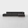 A modern, dark gray, L-shaped sectional sofa with clean lines and a low-profile design sits on a light gray floor against a plain white background.