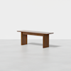 A minimalist wooden bench with a flat rectangular seat and two wide legs, placed on a light gray floor against a plain white background.