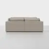 A modern, light beige sectional sofa viewed from the back, set against a plain white background. The sofa has clean lines, boxy cushions, and a minimalist design.