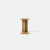 A small, minimalist wooden side table with a square top and base, featuring a central vertical support, set against a plain white background.