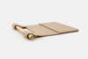 A wooden rolling pin attached to a flat, rectangular, tan felt mat with a fold line, displayed on a white background.