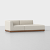 A modern beige sectional sofa with clean lines, low backrest, and wooden base, set against a plain white background.