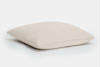 A plain, square beige pillow with a smooth fabric texture, shown against a white background.