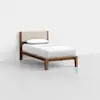 A single bed with a wooden frame, beige upholstered headboard, and white bedding with one pillow, set against a plain white wall and floor.