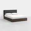 A modern wooden bed frame with a dark upholstered headboard, neatly made with white bedding and two pillows, set against a plain white background.