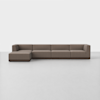 A modern, brown sectional sofa with clean lines and low backrests is placed on a smooth, light-colored floor against a plain white background.