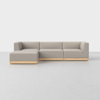 A modern, L-shaped sectional sofa with light gray upholstery and a wooden base, set against a plain white background.