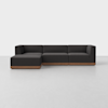 A modern sectional sofa with dark gray upholstery and a low, wooden base, positioned on a light gray floor against a plain white background.