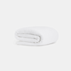 A neatly folded white blanket or sheet placed on a plain white background.