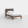 A single wooden bed with a brown upholstered headboard, white bedsheet, and a white pillow, set in a minimal, empty room with light gray floors and white walls.