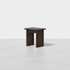 A small, modern dark wood side table with a rectangular top and two wide, flat legs, set against a plain white background.