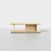 Minimalist wooden coffee table with a rectangular top, open sides, and a central vertical divider on a matching base, placed against a plain white background.