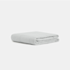 A neatly folded, light gray blanket or comforter is placed on a plain white background.