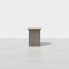 A minimalist, rectangular wooden pedestal table with a vertical slit in the center, set against a plain white background.