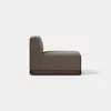 A modern armless brown upholstered lounge chair with a wooden base, shown from the side, set against a plain white background.