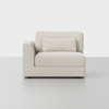A modern, light beige upholstered armchair with a left armrest and a matching rectangular cushion, set against a plain white background.