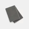 A neatly folded, dark gray towel is placed on a plain white background.