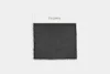 A square, dark gray cloth with a textured surface and scalloped edges, centered on a plain white background.