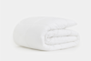 A neatly folded, white, quilted comforter displayed on a plain white background.