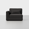 A modern, dark gray upholstered armchair with a left armrest and a matching rectangular cushion, set against a plain light gray background.