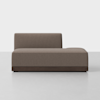 A modern, minimalist brown chaise lounge with a low backrest on the left side, upholstered in fabric, and supported by a dark wooden base, placed on a light gray floor against a plain white background.