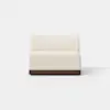 A modern armless loveseat with cream-colored upholstery and a dark wooden base, set against a plain white background.