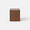 A modern wooden nightstand with a rectangular shape, featuring one open drawer and a lower closed compartment, set against a plain light gray background.