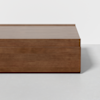 A modern, rectangular wooden coffee table with clean lines and a smooth finish, placed on a light grey floor against a plain white background.