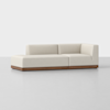 A modern L-shaped sectional sofa with cream-colored upholstery and a wooden base, set against a plain white background.